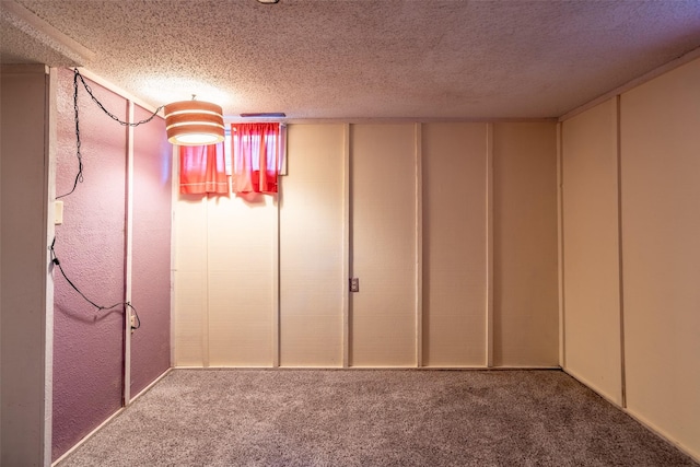 basement with carpet and a textured ceiling