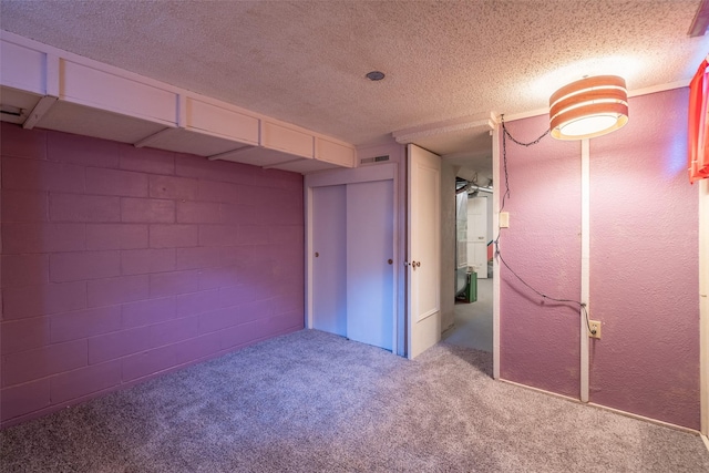 unfurnished bedroom with a textured ceiling and light colored carpet