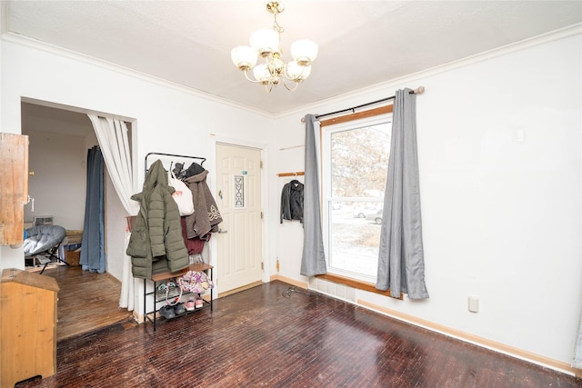 entrance foyer featuring dark hardwood / wood-style floors, plenty of natural light, and crown molding