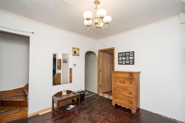 interior space featuring wood-type flooring, crown molding, and an inviting chandelier