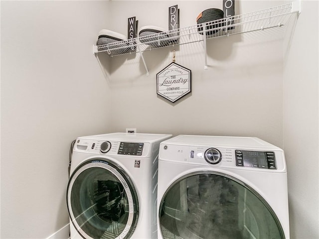 clothes washing area with washer and clothes dryer