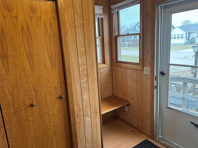 mudroom featuring hardwood / wood-style flooring and wood walls