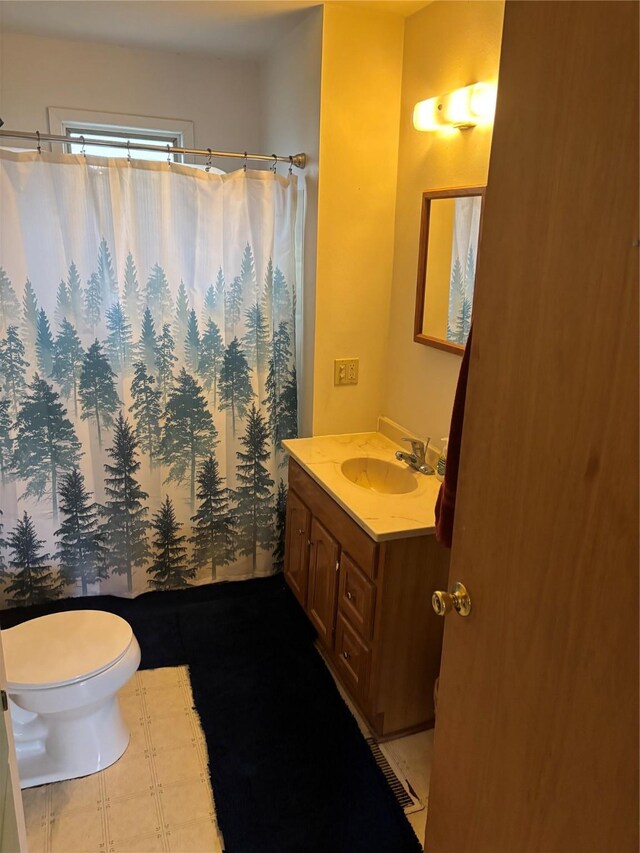 bathroom featuring vanity, curtained shower, and toilet