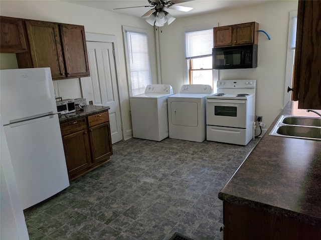 903 E St, Grinnell, IA 50112 - kitchen with white appliances, washing machine and dryer, ceiling fan, and dark countertops