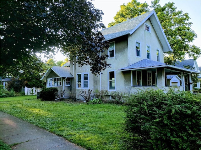 903 E St, Grinnell, IA 50112 - view of front of home with stucco siding and a shingled roof
