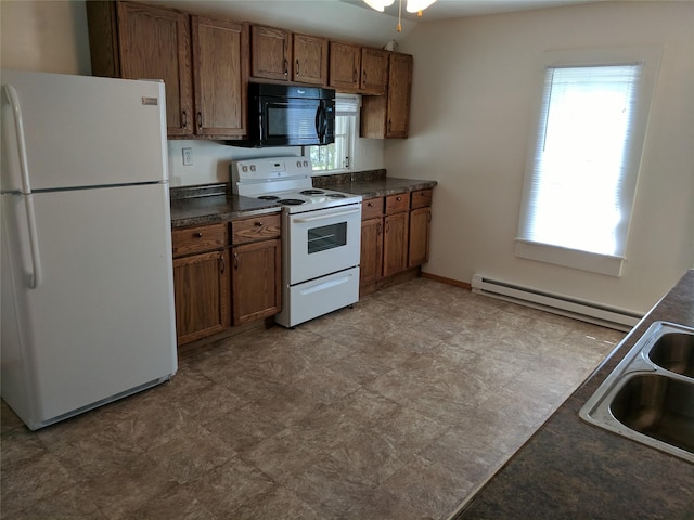 903 E St, Grinnell, IA 50112 - kitchen with white appliances, dark countertops, a baseboard radiator, brown cabinets, and light floors