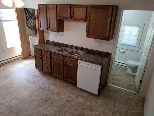 kitchen with dishwasher, washer / dryer, sink, and a baseboard heating unit