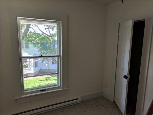 903 E St, Grinnell, IA 50112 - carpeted spare room with a baseboard heating unit
