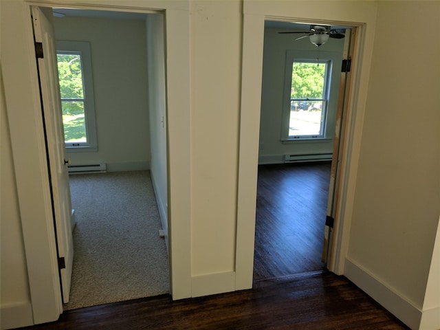 903 E St, Grinnell, IA 50112 - hall featuring a baseboard radiator, baseboard heating, and dark wood-style floors
