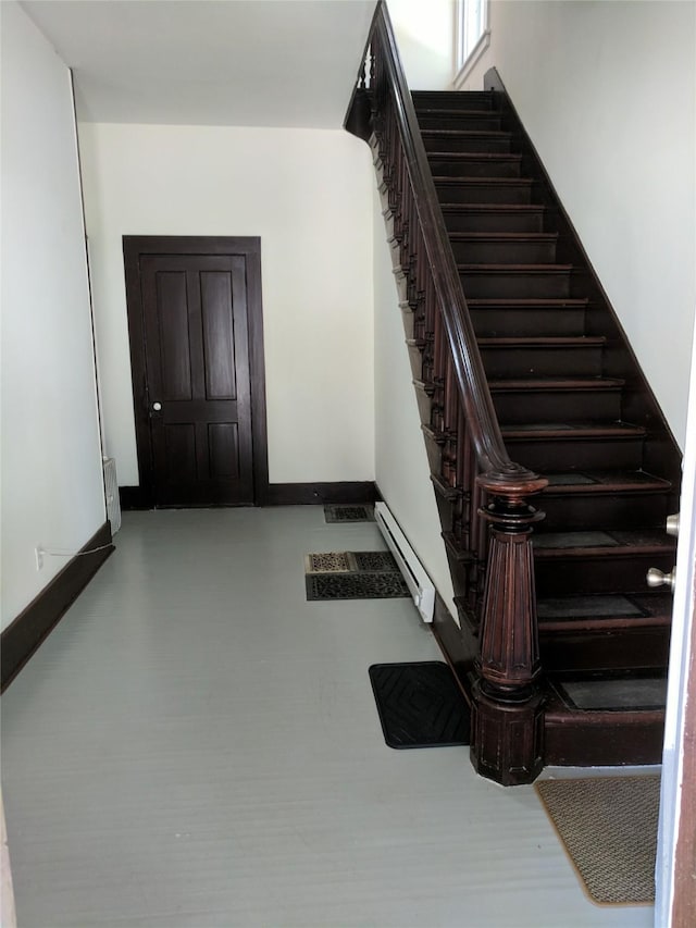 903 E St, Grinnell, IA 50112 - stairway with a baseboard radiator and baseboards