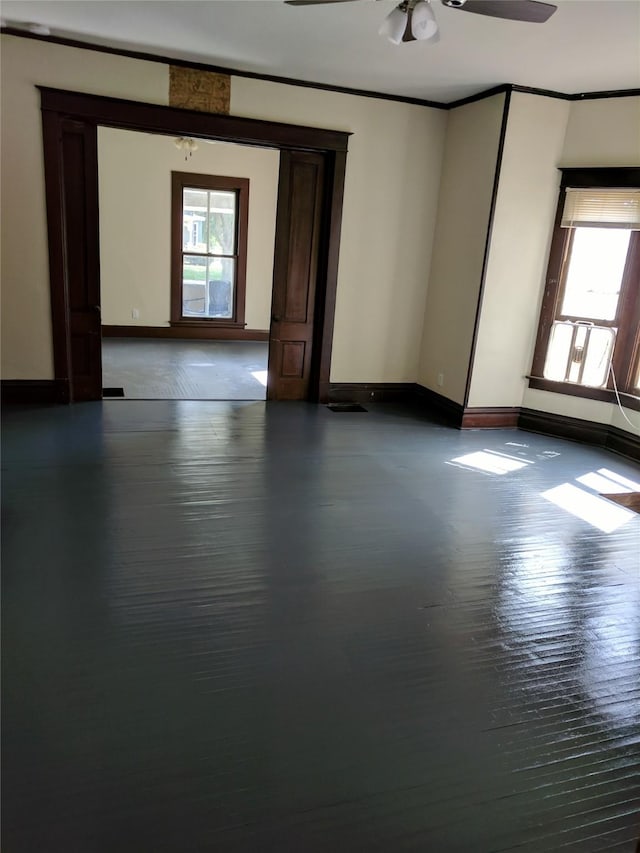 903 E St, Grinnell, IA 50112 - empty room featuring a ceiling fan and crown molding