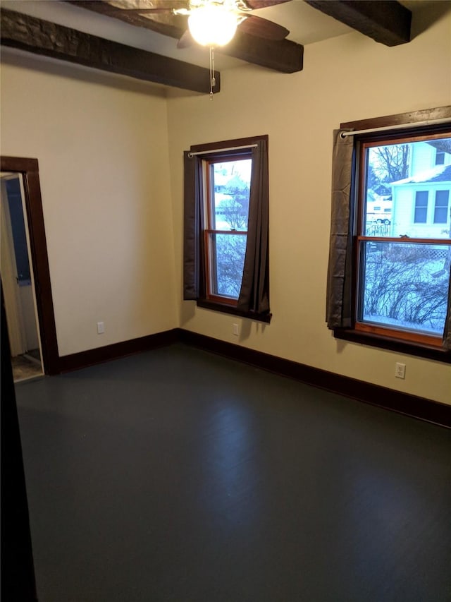 903 E St, Grinnell, IA 50112 - spare room with plenty of natural light, a ceiling fan, and beamed ceiling