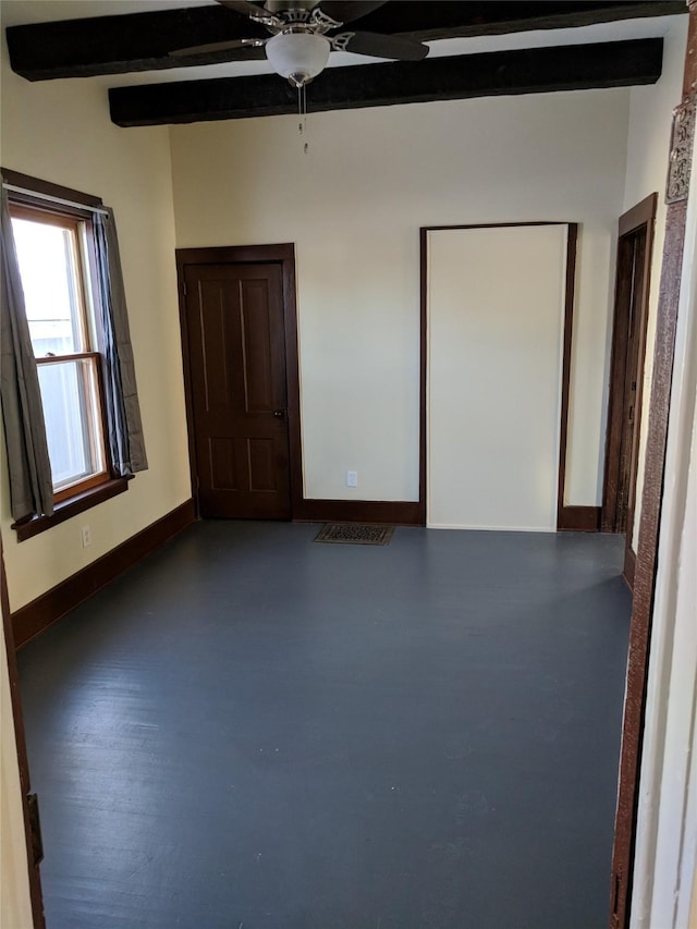 903 E St, Grinnell, IA 50112 - unfurnished room with a ceiling fan and beam ceiling