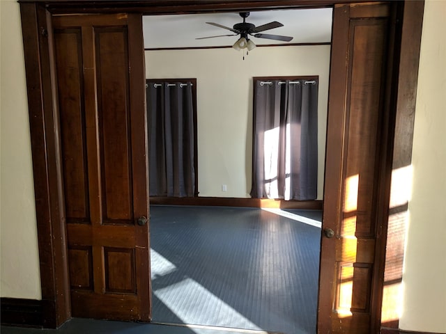 903 E St, Grinnell, IA 50112 - spare room with a ceiling fan and ornamental molding