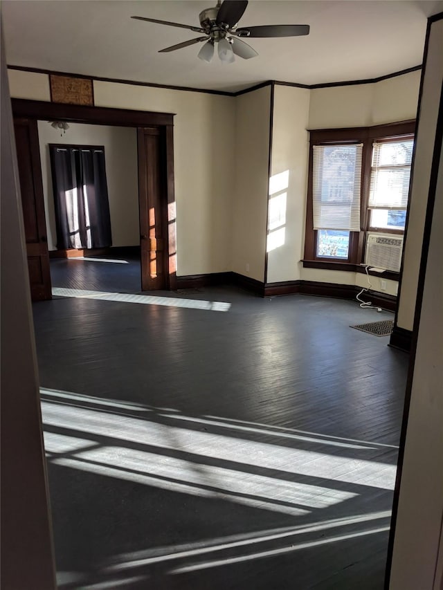 903 E St, Grinnell, IA 50112 - empty room with wood finished floors, ceiling fan, cooling unit, and ornamental molding