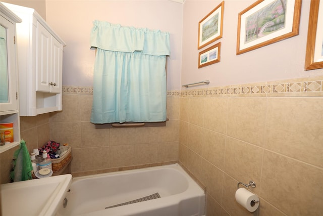 bathroom with tile walls and a washtub