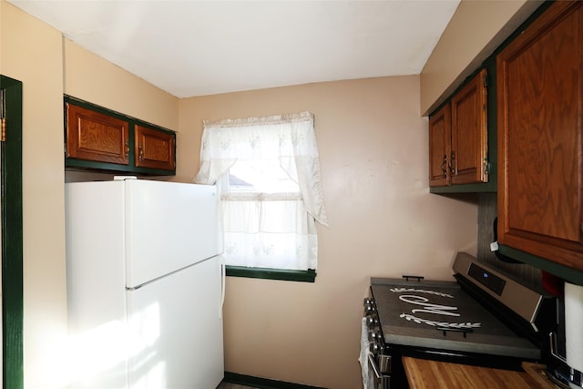 kitchen featuring stainless steel stove and white refrigerator