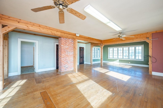 unfurnished living room featuring ceiling fan and wood-type flooring