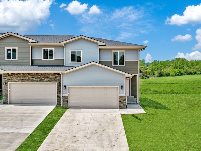 view of front of home with a front yard and a garage