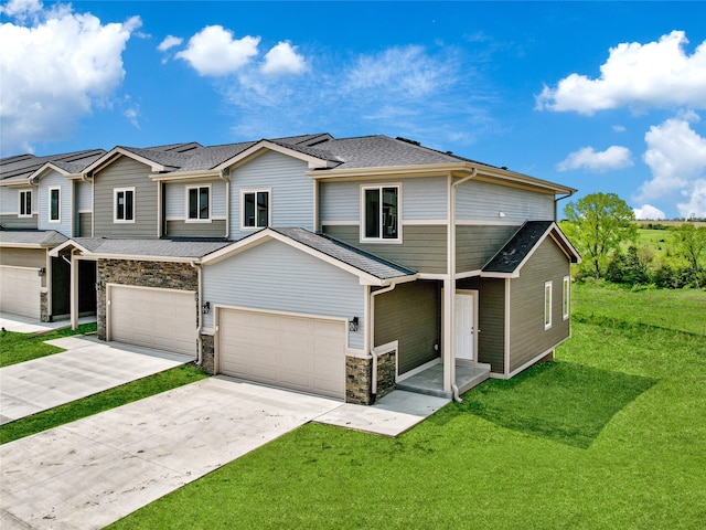 view of front of property with a front yard and a garage