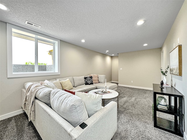 carpeted living room featuring a textured ceiling