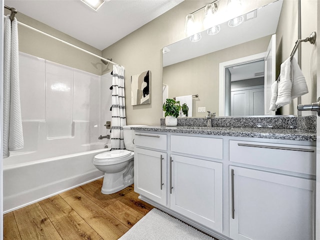 full bathroom with hardwood / wood-style floors, vanity, toilet, and shower / bathtub combination with curtain