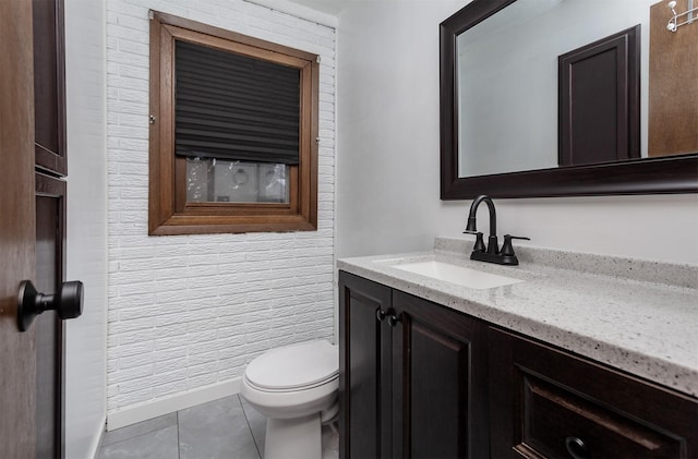 bathroom featuring vanity, tile patterned floors, and toilet