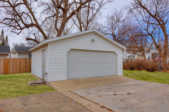 detached garage featuring fence