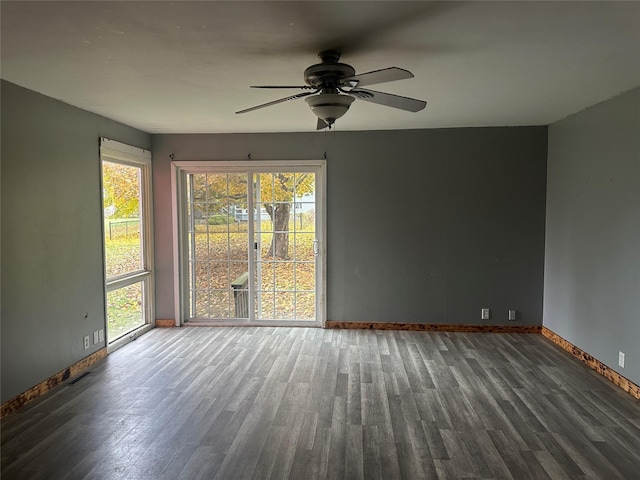 unfurnished room with dark hardwood / wood-style floors and ceiling fan