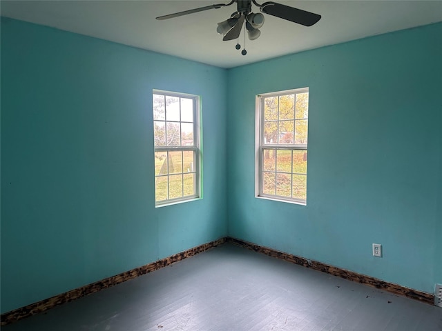 spare room featuring hardwood / wood-style flooring and ceiling fan