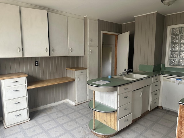 kitchen with white cabinets, dishwasher, and sink