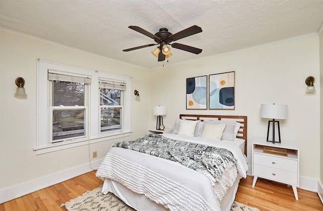 bedroom with crown molding, ceiling fan, hardwood / wood-style flooring, and a textured ceiling