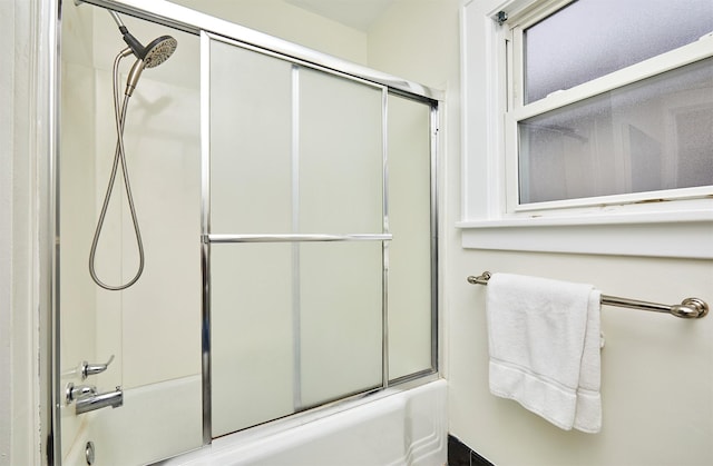 bathroom with shower / bath combination with glass door