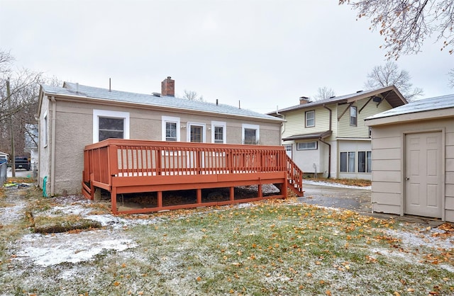 rear view of property with a yard and a deck