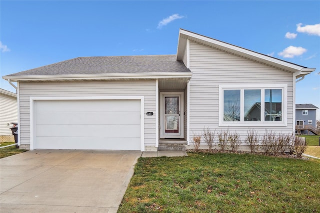 view of front of house featuring a garage and a front lawn