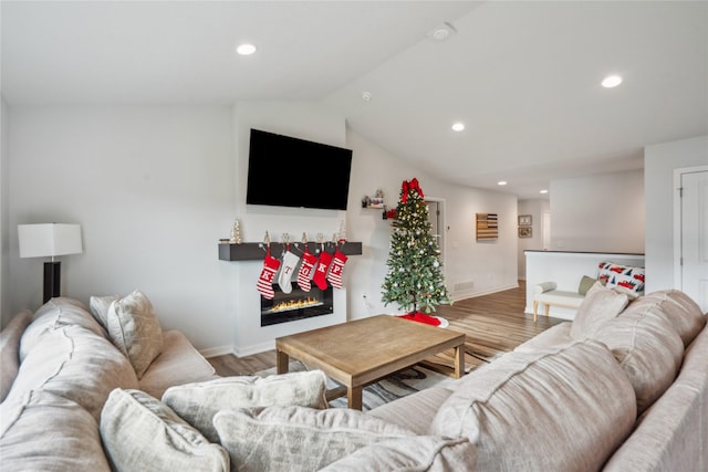 living room with wood-type flooring and lofted ceiling