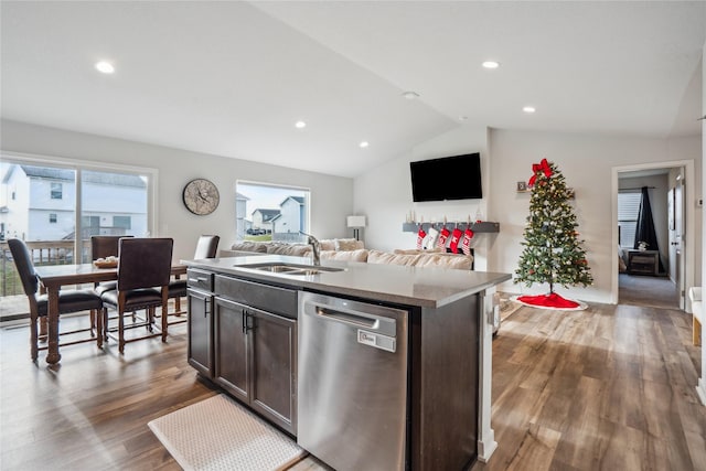 kitchen featuring dark brown cabinetry, vaulted ceiling, sink, dishwasher, and an island with sink