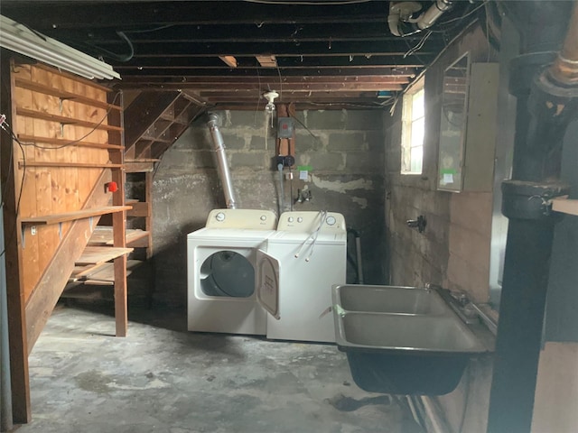 basement featuring washing machine and clothes dryer and sink