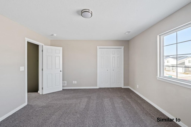 unfurnished bedroom featuring carpet floors and a closet