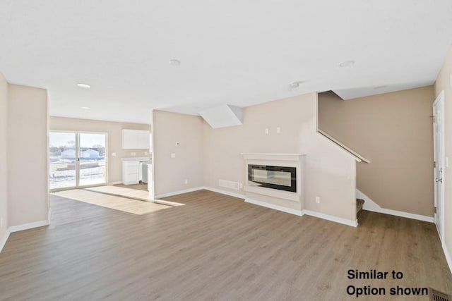 unfurnished living room with light wood-type flooring