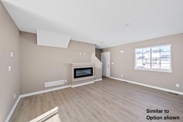 unfurnished living room with light wood-type flooring