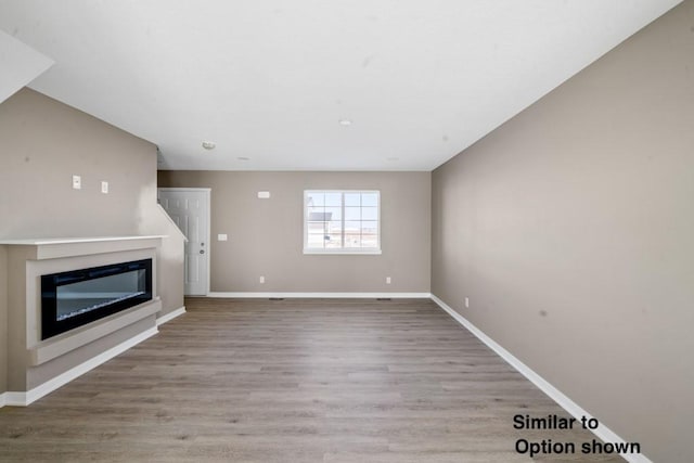 unfurnished living room with light hardwood / wood-style flooring