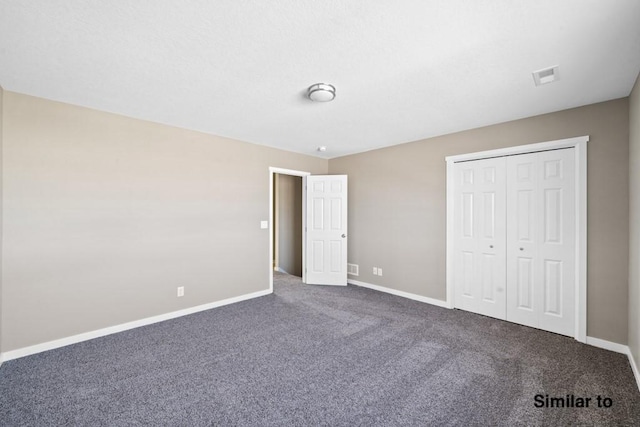 unfurnished bedroom with a closet and carpet