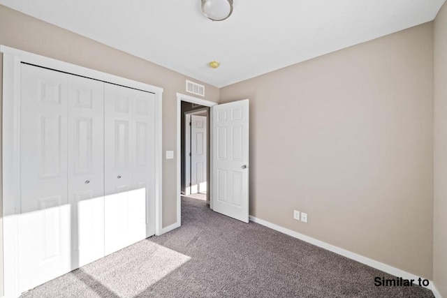 unfurnished bedroom with a closet and carpet floors