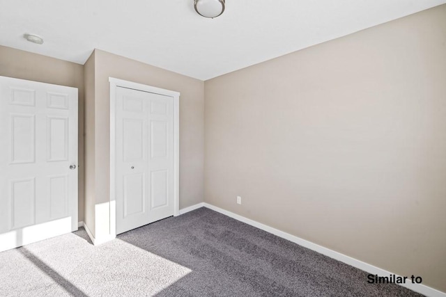 unfurnished bedroom with a closet and carpet flooring