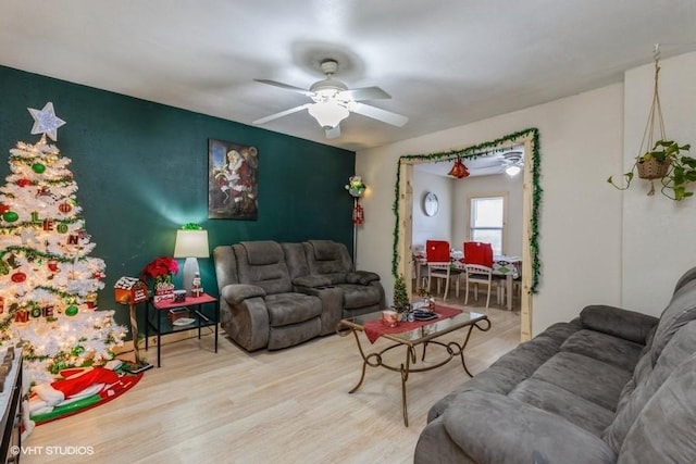 living room with ceiling fan and light wood-type flooring