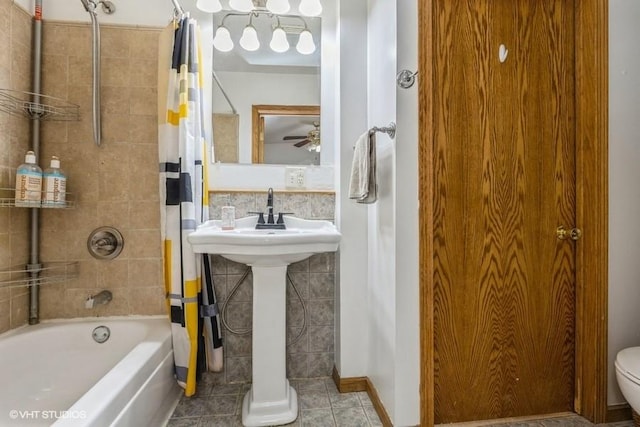 bathroom featuring toilet, tile patterned flooring, and shower / bath combo with shower curtain