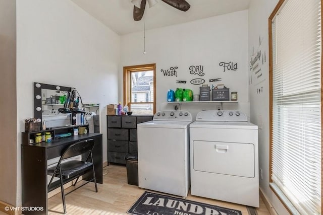 laundry room with ceiling fan, washing machine and dryer, and light hardwood / wood-style floors