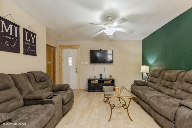 living room with ceiling fan and light wood-type flooring