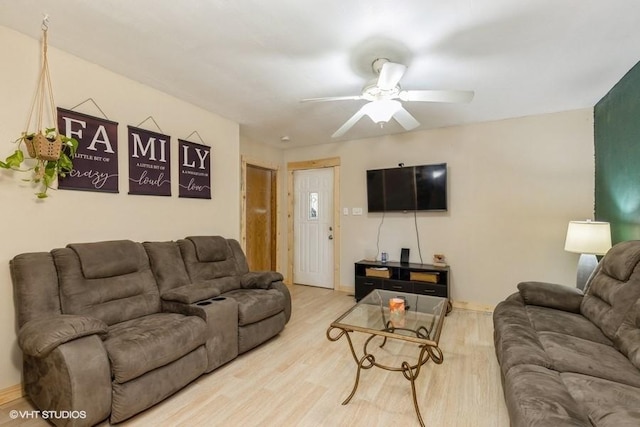 living room featuring ceiling fan and hardwood / wood-style flooring